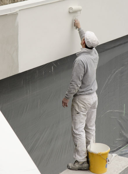 Painter painting a commercial building
