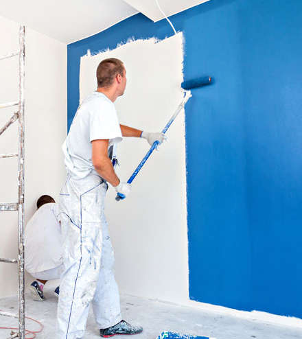 man painting home wall blue